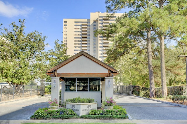49 Briar Hollow Ln Unit 302, Houston, TX 77027 - view of property featuring driveway and fence