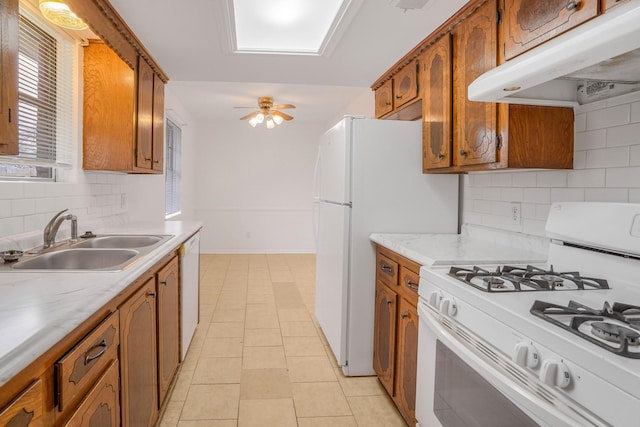 kitchen featuring sink, white appliances, light tile patterned floors, ceiling fan, and tasteful backsplash