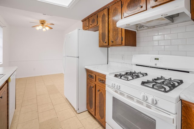 kitchen featuring ceiling fan, white appliances, light tile patterned floors, and backsplash