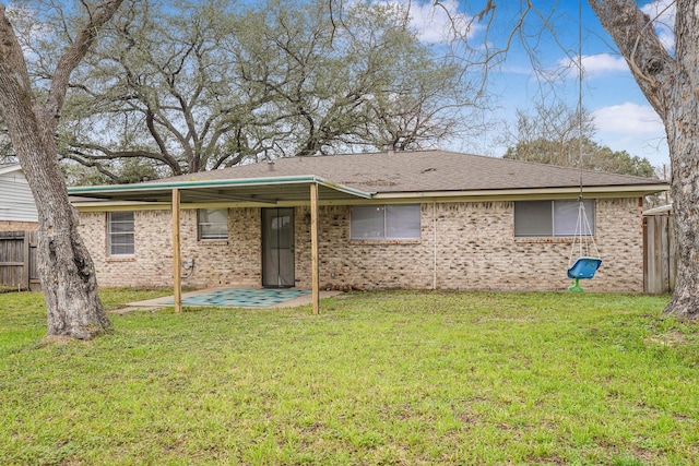 rear view of house with a lawn