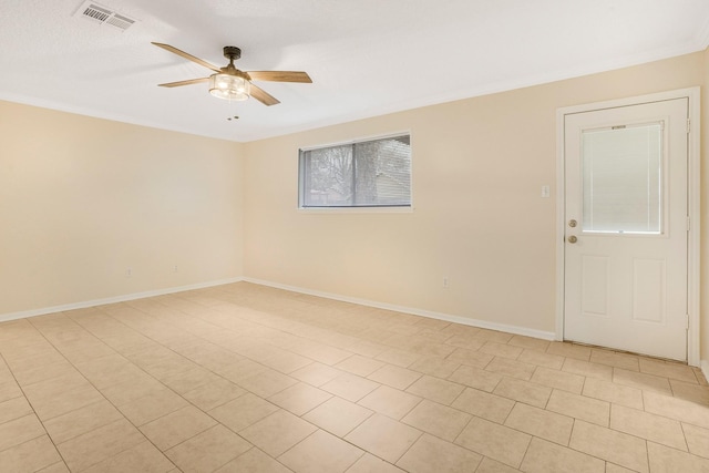 spare room featuring ornamental molding and ceiling fan