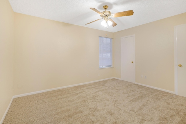 unfurnished room with ceiling fan, carpet floors, and a textured ceiling