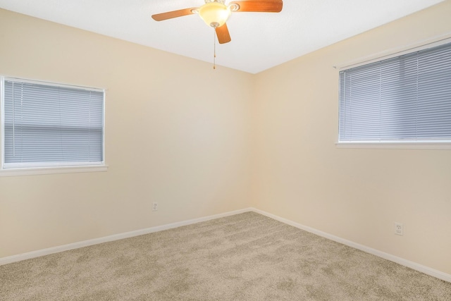 carpeted spare room with ceiling fan