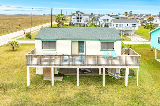 16725 Captain Bligh Rd, Jamaica Beach, TX 77554 - back of house with a deck, a residential view, a yard, and roof with shingles