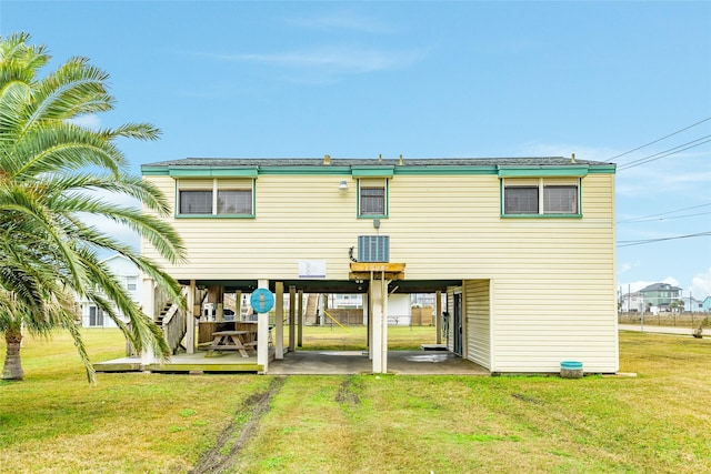 rear view of property with a lawn