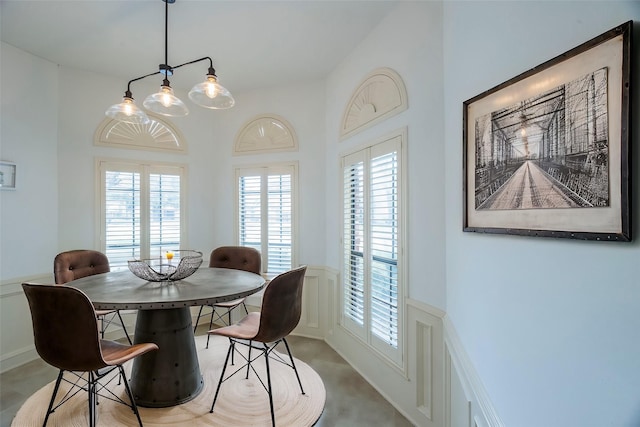 dining room with a wainscoted wall and a decorative wall