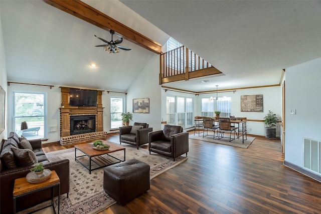 living room featuring a healthy amount of sunlight, dark hardwood / wood-style floors, and a fireplace