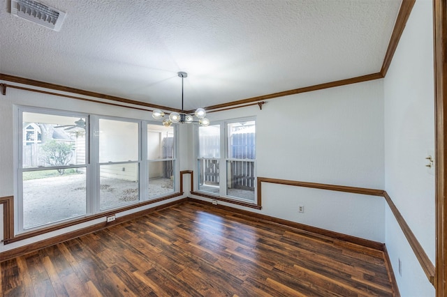 empty room featuring dark wood-type flooring, a wealth of natural light, visible vents, and ornamental molding