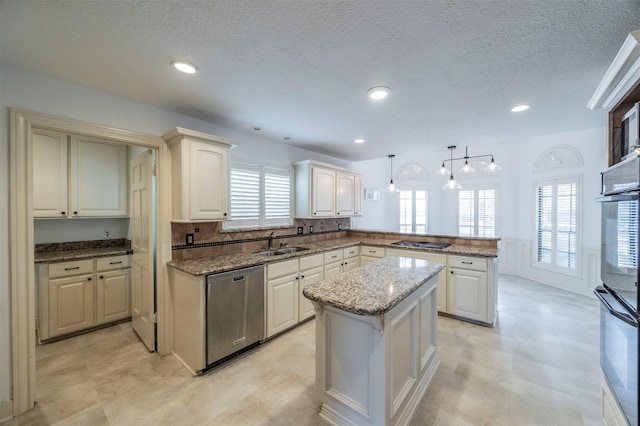 kitchen with a peninsula, a sink, a center island, dishwasher, and decorative light fixtures