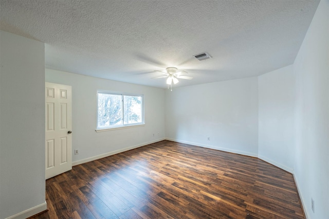 unfurnished room featuring baseboards, visible vents, ceiling fan, dark wood-style flooring, and a textured ceiling