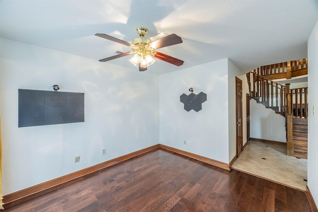 interior space featuring ceiling fan, baseboards, and wood finished floors