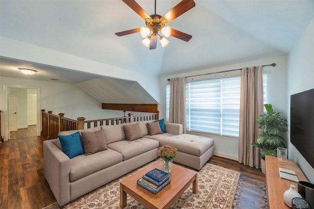 living area with dark wood-style floors, vaulted ceiling, baseboards, and a ceiling fan