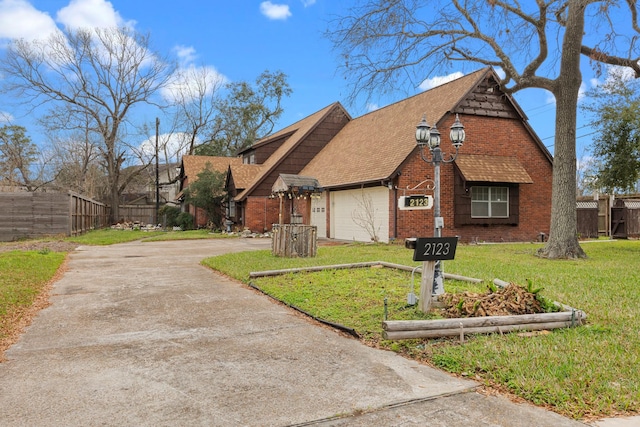 view of front of home featuring a garage and a front yard