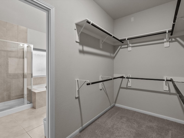 spacious closet featuring light tile patterned floors