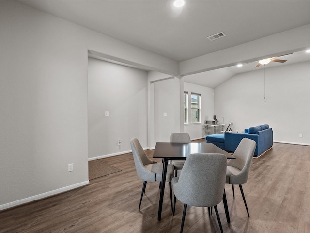 dining room featuring ceiling fan, visible vents, baseboards, and wood finished floors