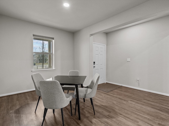 dining area featuring wood finished floors and baseboards