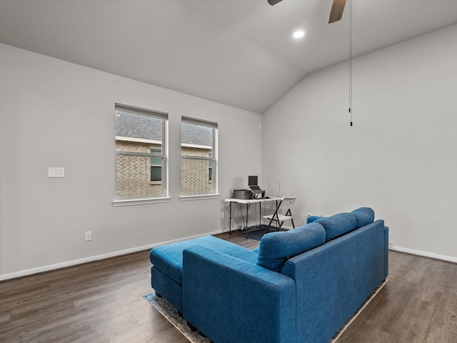 living room with dark wood-type flooring, ceiling fan, and vaulted ceiling