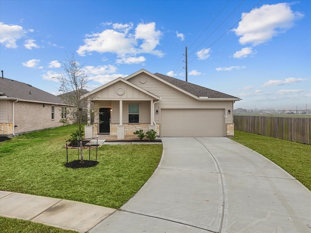 view of front of property featuring a front lawn, concrete driveway, an attached garage, and fence