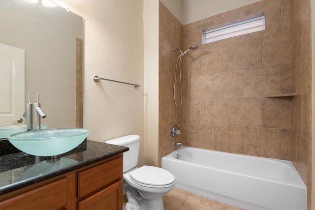 full bathroom featuring tiled shower / bath combo, vanity, tile patterned floors, and toilet