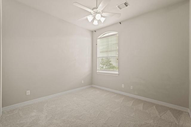 unfurnished room with ceiling fan and light carpet