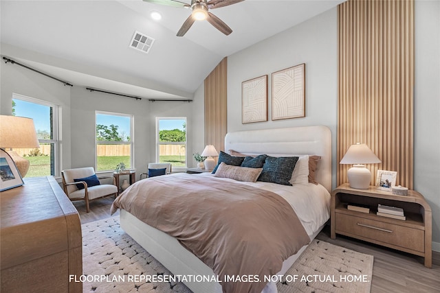 bedroom with lofted ceiling, ceiling fan, light wood-style flooring, visible vents, and access to exterior