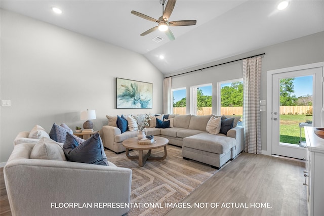 living room featuring ceiling fan, plenty of natural light, lofted ceiling, and light hardwood / wood-style floors