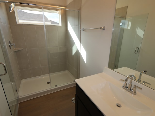 134 Spring Rose Dr, Magnolia, TX 77354 - full bathroom featuring a shower stall, vanity, and wood finished floors