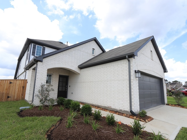 134 Spring Rose Dr, Magnolia, TX 77354 - view of front facade featuring brick siding, a garage, and driveway