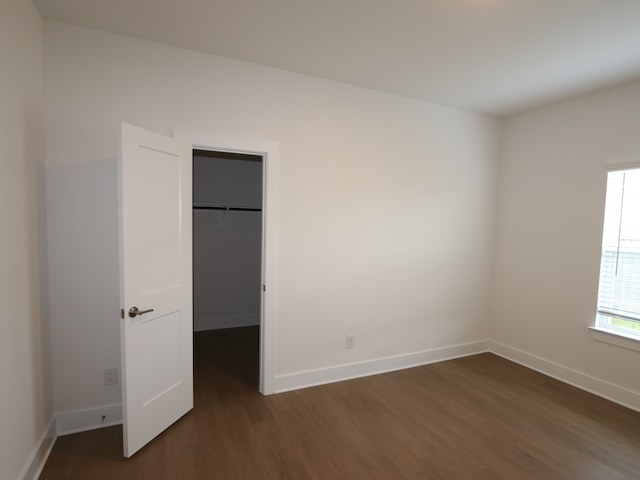 134 Spring Rose Dr, Magnolia, TX 77354 - unfurnished bedroom featuring dark wood-type flooring, a walk in closet, and a closet