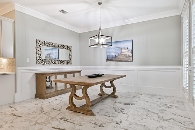 dining area featuring crown molding and an inviting chandelier