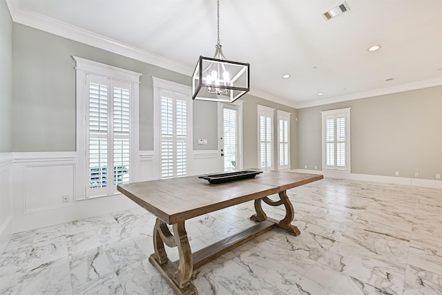 dining space featuring ornamental molding and a chandelier