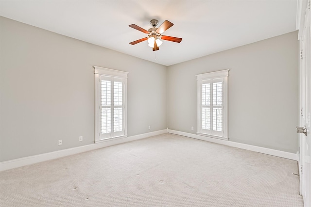 spare room featuring ceiling fan and light carpet