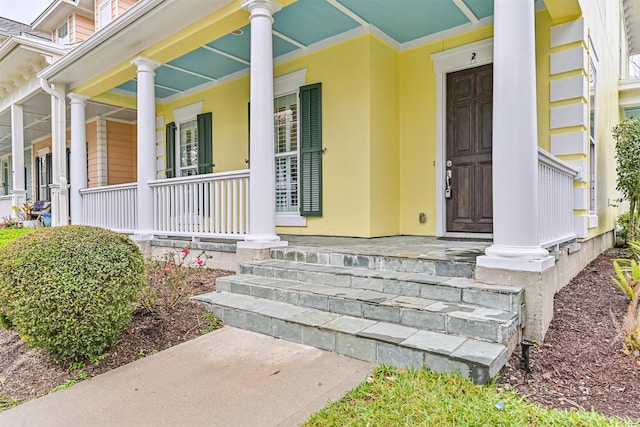 view of exterior entry with covered porch