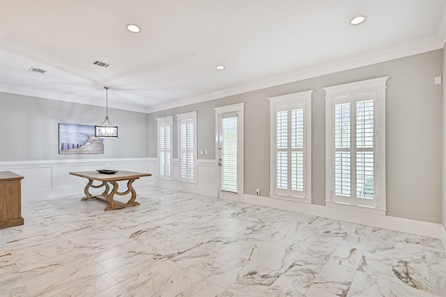 entryway with ornamental molding and a healthy amount of sunlight