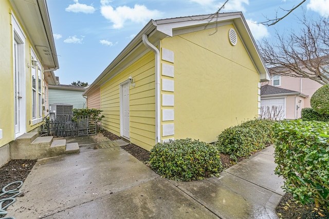 view of property exterior featuring a patio and cooling unit