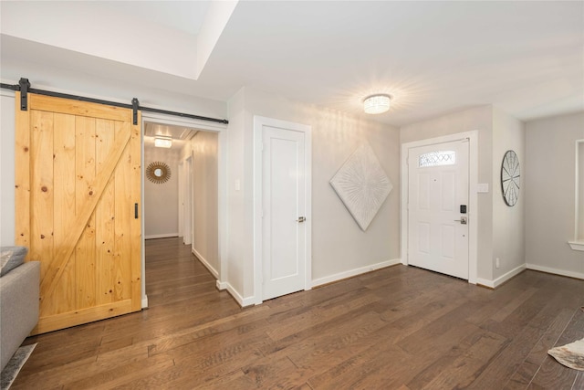 foyer featuring dark hardwood / wood-style floors and a barn door