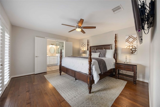 bedroom featuring dark wood-type flooring, ceiling fan, and connected bathroom