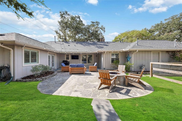 back of house with a yard, a patio area, and an outdoor living space with a fire pit