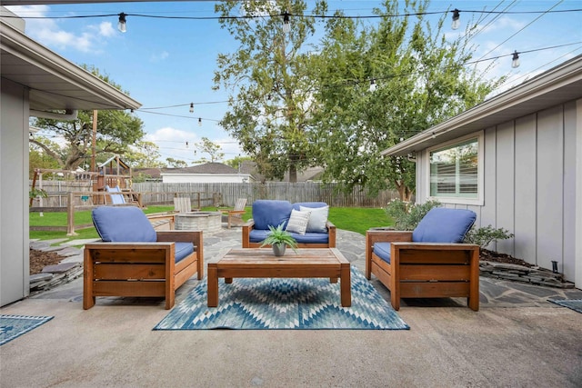 view of patio with an outdoor living space with a fire pit and a playground