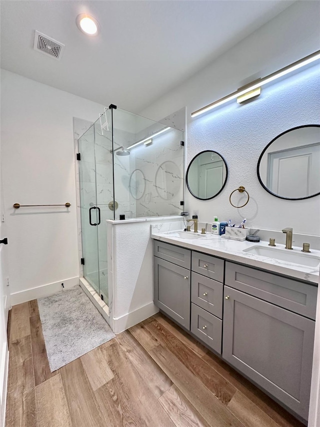 bathroom featuring vanity, hardwood / wood-style floors, and walk in shower