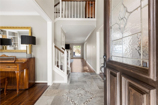 foyer featuring ornamental molding and dark hardwood / wood-style floors