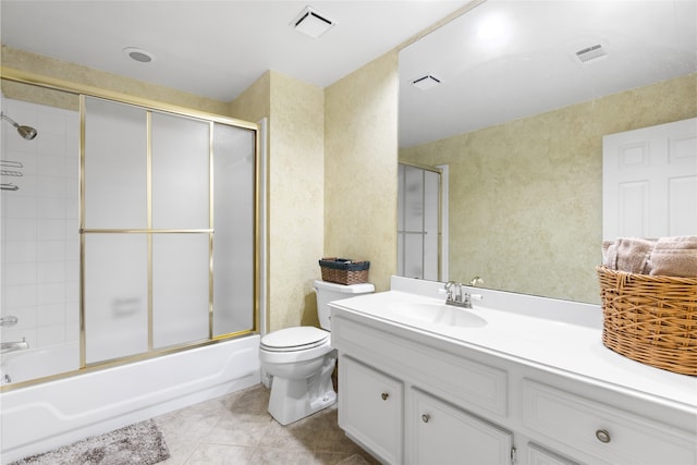 full bathroom featuring enclosed tub / shower combo, vanity, toilet, and tile patterned flooring