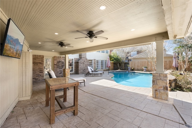 view of pool with a patio and ceiling fan