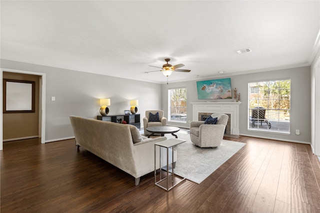 living room featuring ceiling fan, ornamental molding, and dark hardwood / wood-style flooring