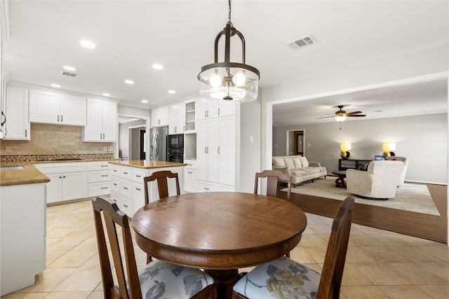 dining area featuring light tile patterned flooring and ceiling fan