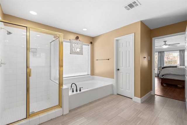 bathroom featuring separate shower and tub