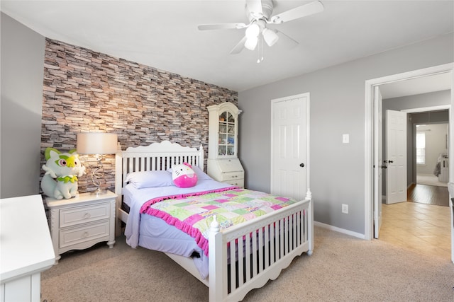 bedroom featuring light colored carpet and ceiling fan