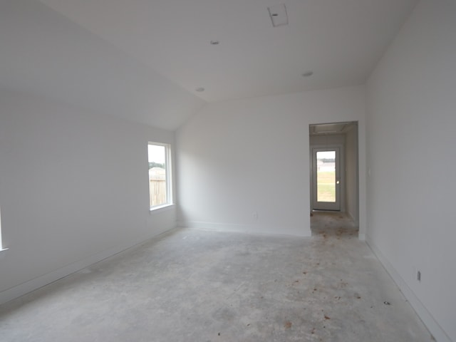740 Autumn Cherry Trl, Magnolia, TX 77354 - unfurnished room featuring healthy amount of natural light, vaulted ceiling, concrete floors, and baseboards