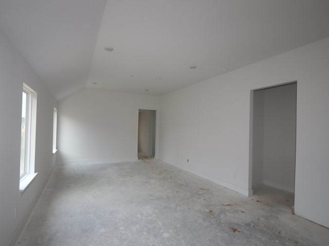 740 Autumn Cherry Trl, Magnolia, TX 77354 - empty room featuring plenty of natural light, lofted ceiling, and baseboards