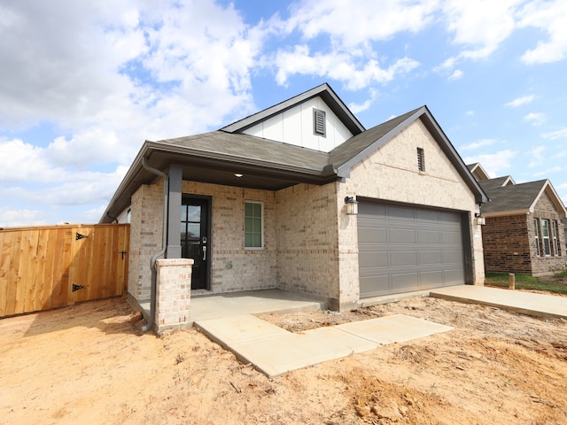740 Autumn Cherry Trl, Magnolia, TX 77354 - view of front facade with brick siding, board and batten siding, a garage, and a gate
